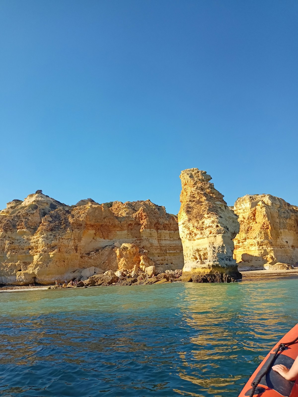 Algarve coastal waters with rocky cliffs and clear blue sea, southern Portugal