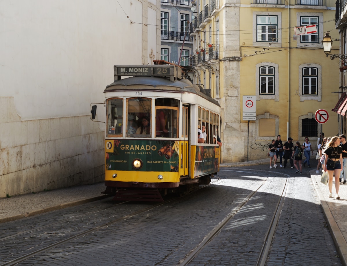 Lisbon's Alfama neighbourhood with colourful tiled buildings and rooftop views over the Tagus