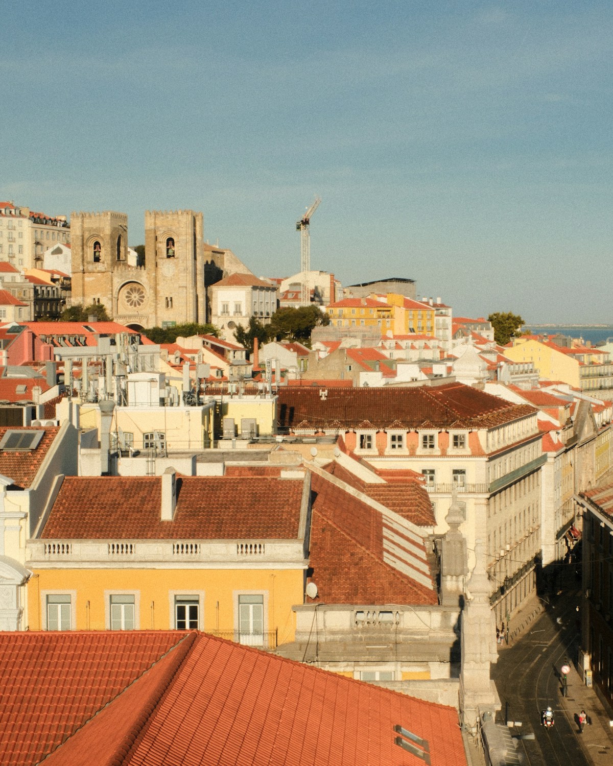 Lisbon's terracotta rooftops with the Sé Cathedral and Tagus river in the background