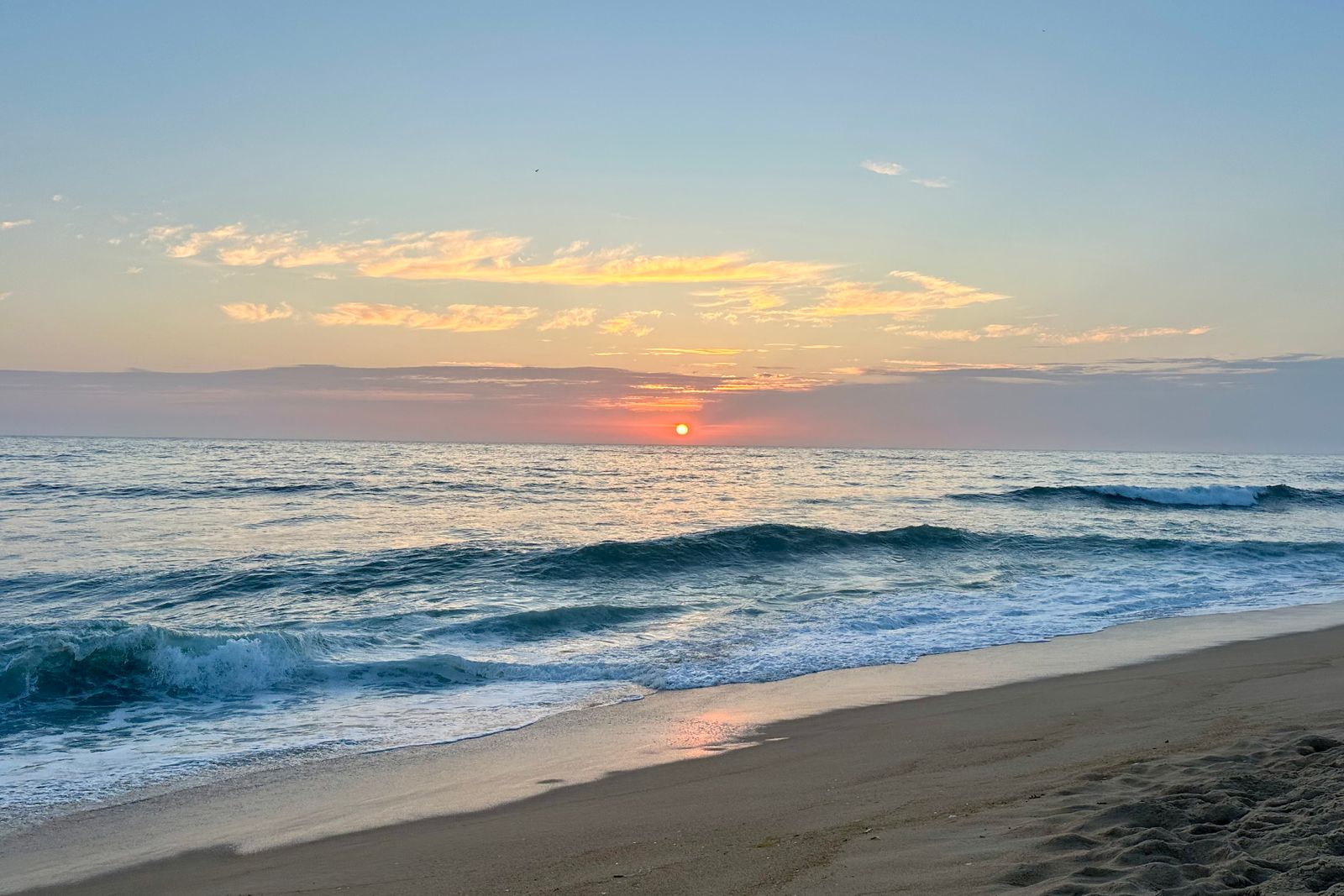 Sunset over the wide sandy beach at Nazaré on Portugal's Silver Coast