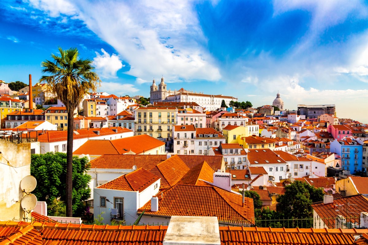 Lisbon's Alfama district panorama with colourful buildings and terracotta rooftops under blue sky