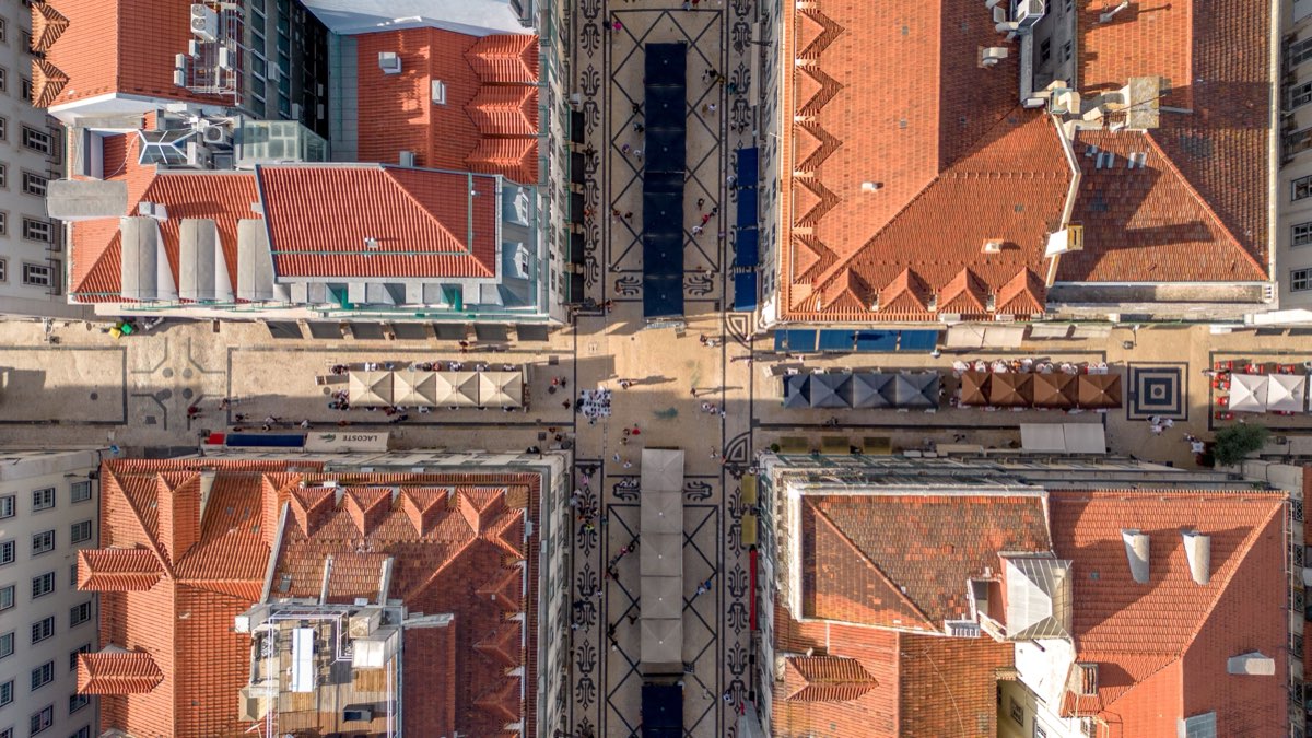 Aerial view of Lisbon's old town streets and terracotta rooftops from above, Portugal