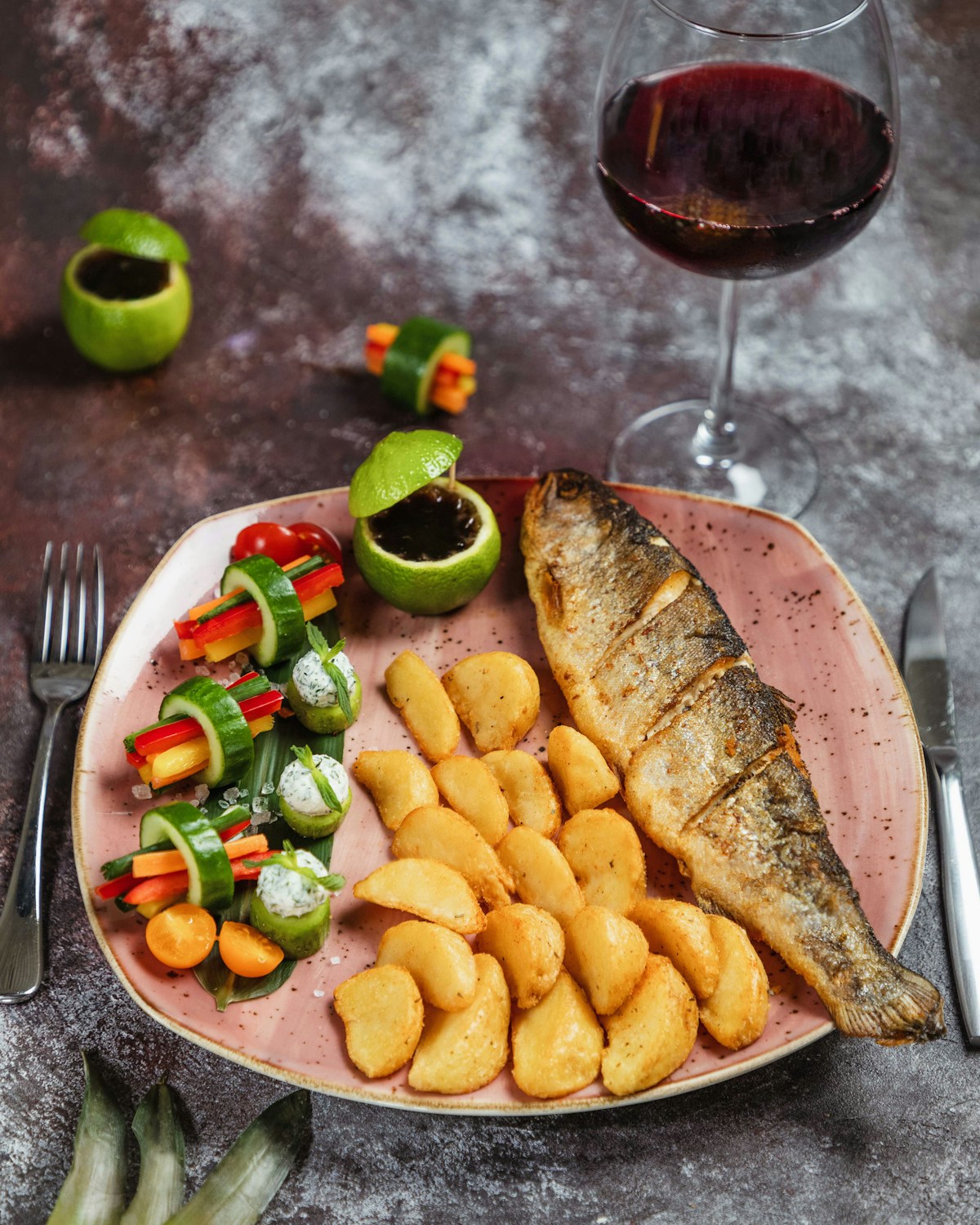 Grilled fish with potatoes, vegetables, and a glass of red wine - traditional island meal on Pico, Azores