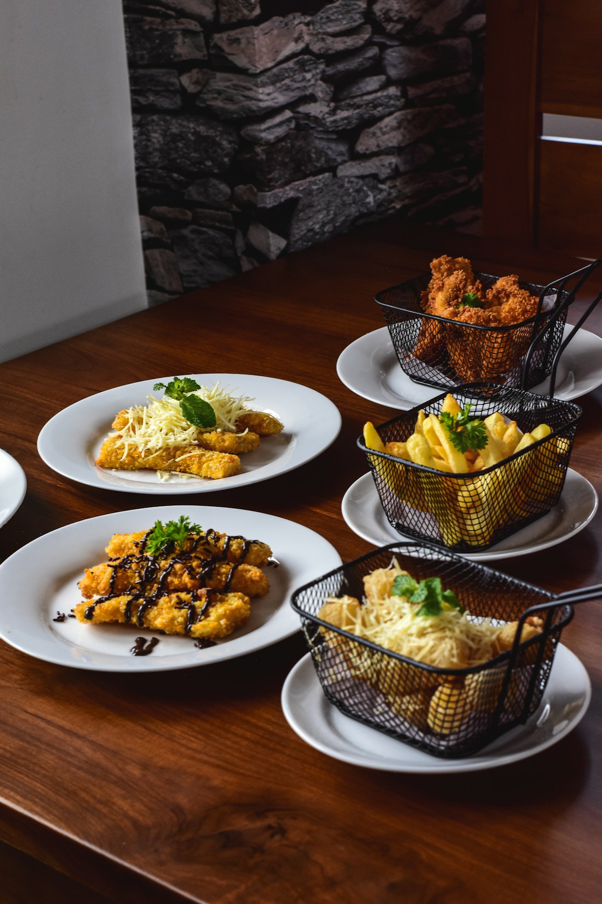 Restaurant table with plates of food including breaded fish and chips - dining out in Santa Maria, Azores