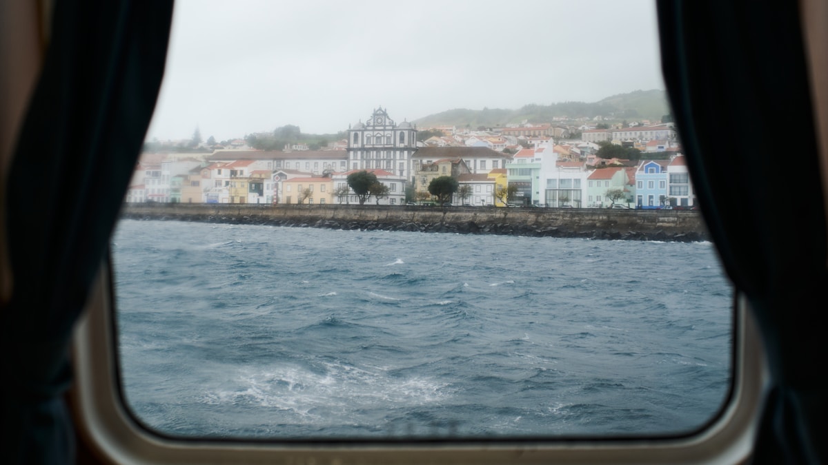 Colourful waterfront buildings of Horta seen from a ferry window, Faial island, Azores, Portugal