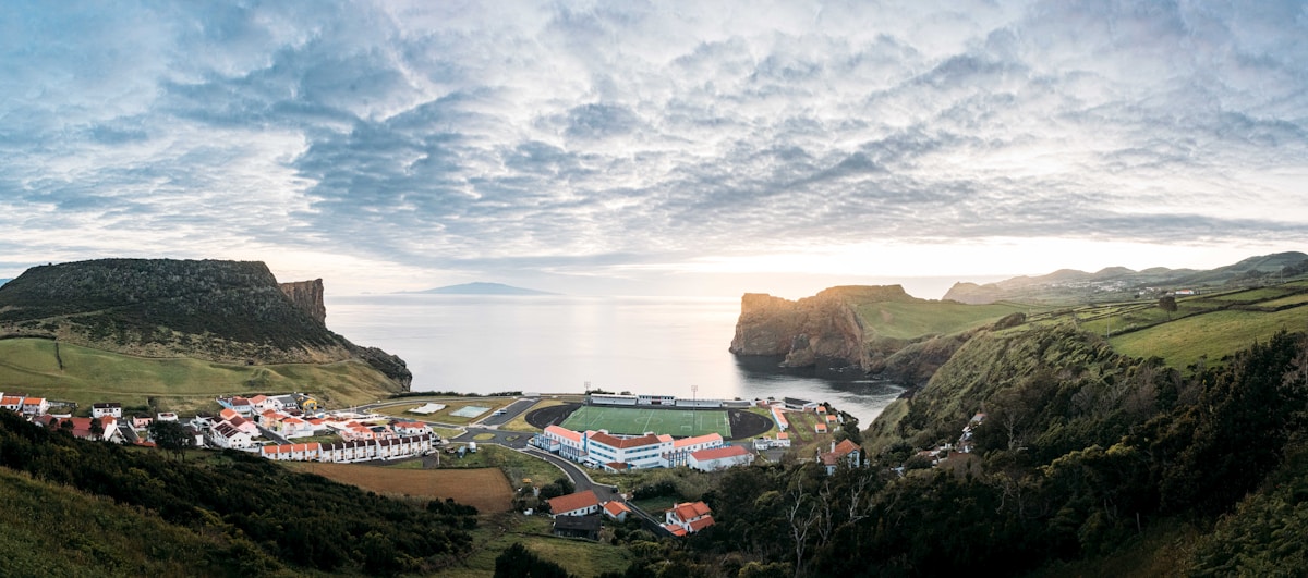 Panoramic view of small coastal village in a sheltered bay between volcanic cliffs, Santa Maria island, Azores, Portugal