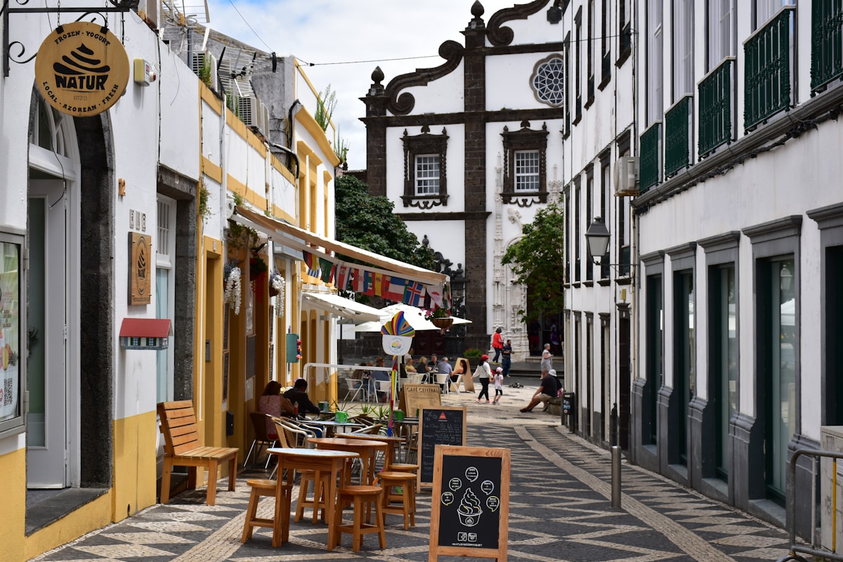 Pedestrian street with outdoor cafes and colourful buildings in Ponta Delgada, São Miguel, Azores, Portugal