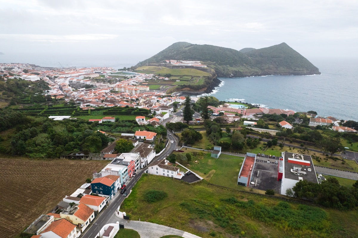 Aerial view of Angra do Heroísmo with terracotta rooftops and Monte Brasil headland, Terceira, Azores, Portugal