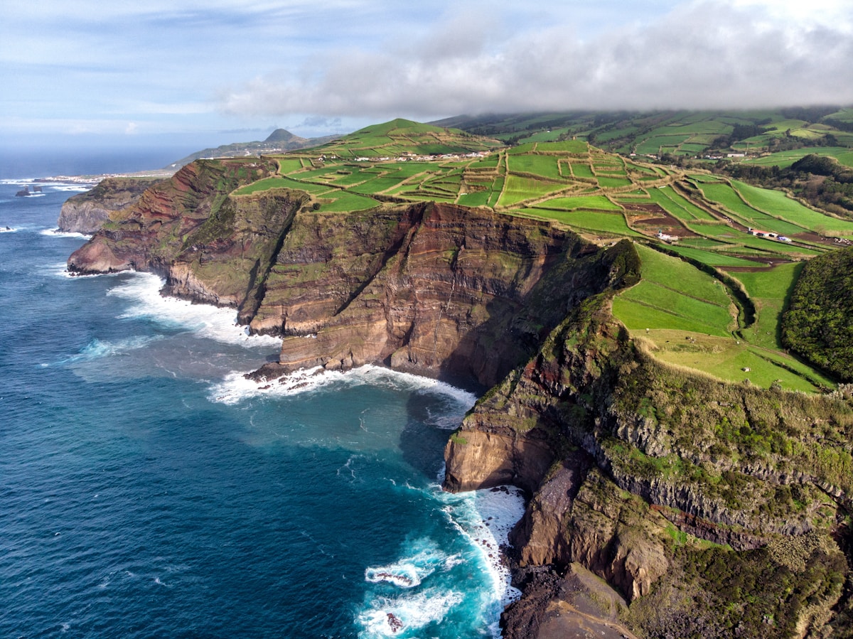 Aerial view of dramatic sea cliffs and green terraced fields, Santa Maria island, Azores
