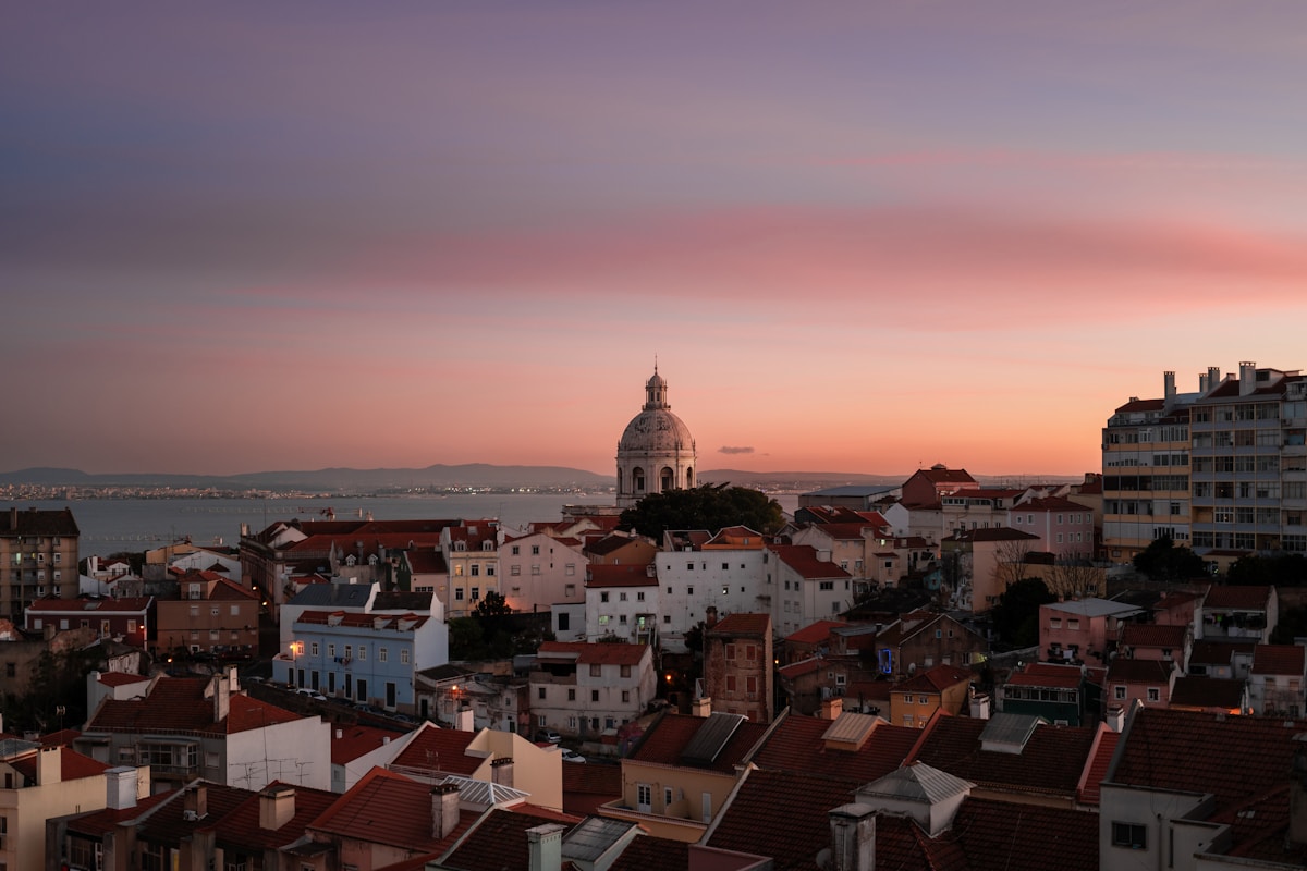 Lisbon rooftops and the National Pantheon dome above the Tagus at sunset, Portugal