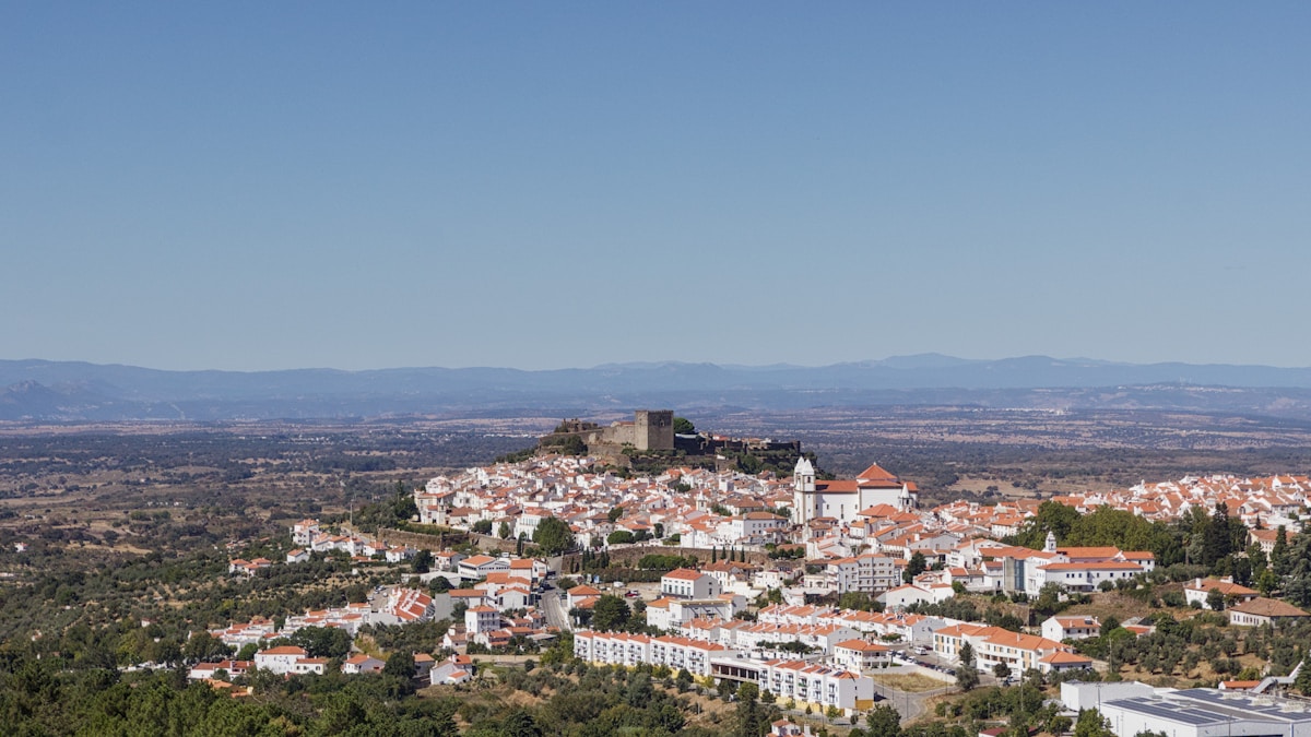 Whitewashed hilltop town with castle above the Alentejo plains, Portugal