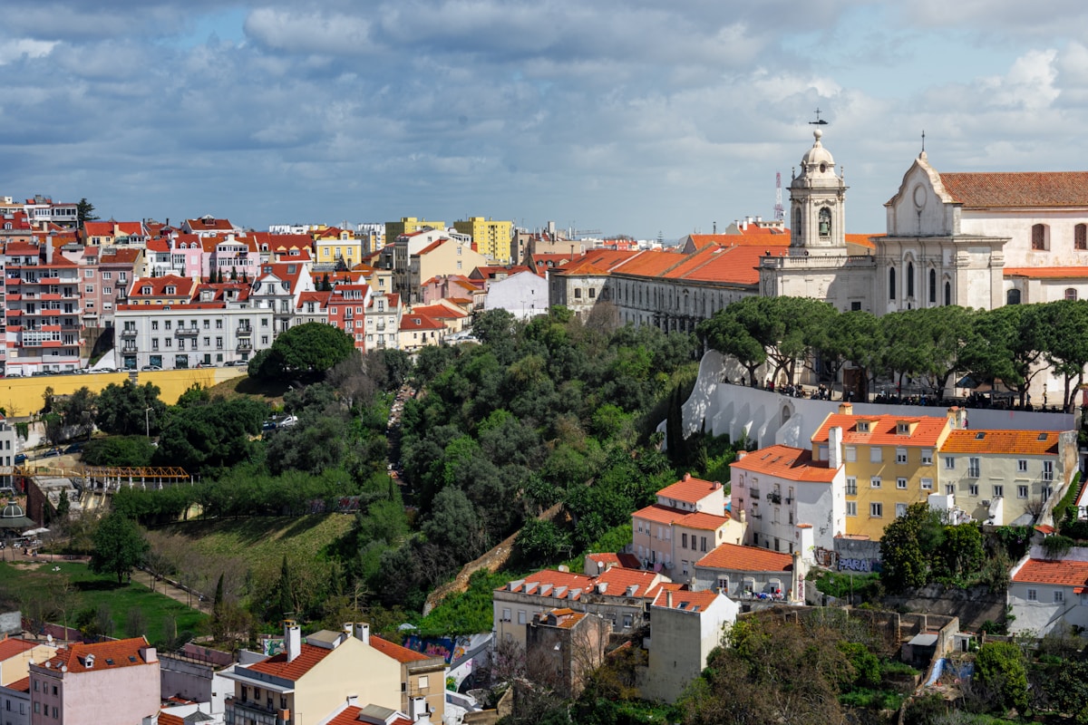 View over Lisbon's Graça neighbourhood with terracotta rooftops and church towers