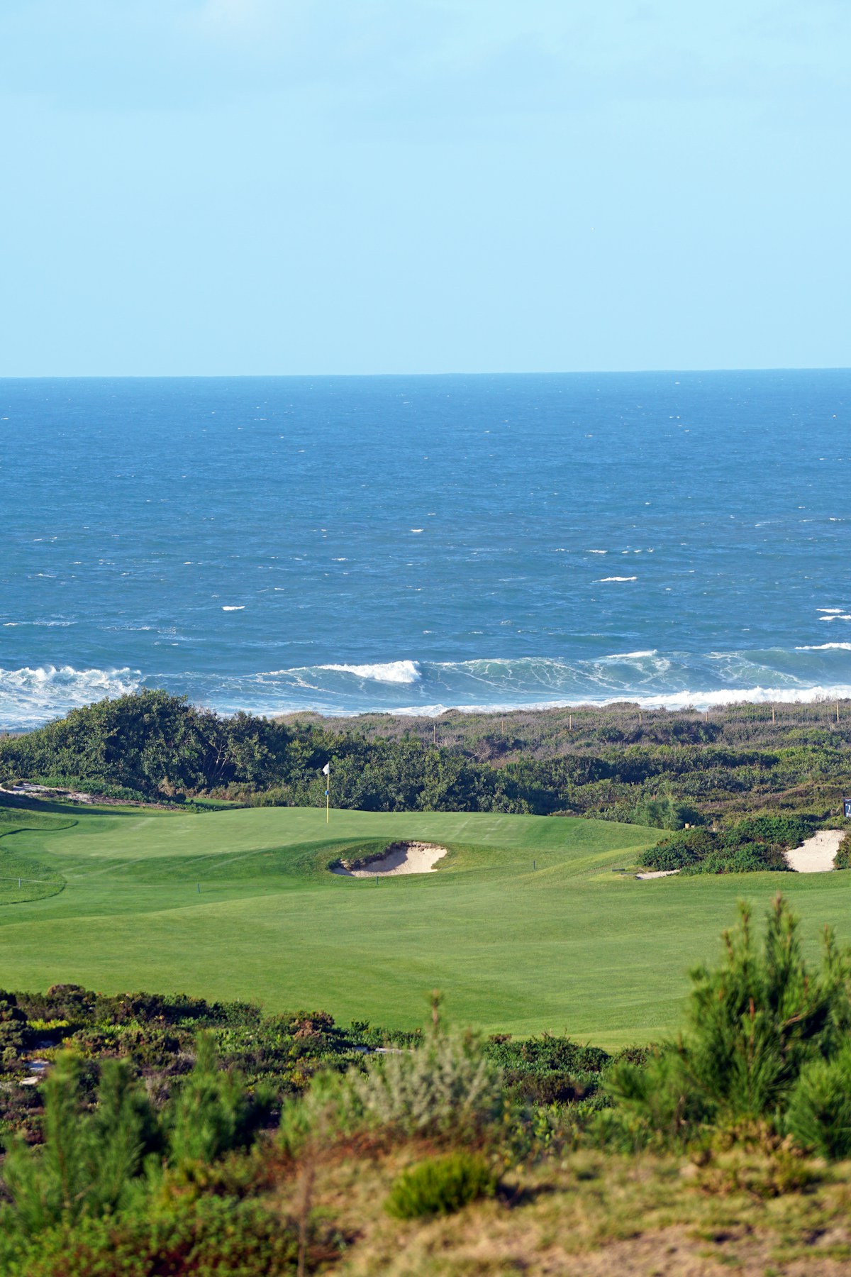 Golf course green with sand bunkers and the Atlantic Ocean in the background, Portugal - Algarve golf