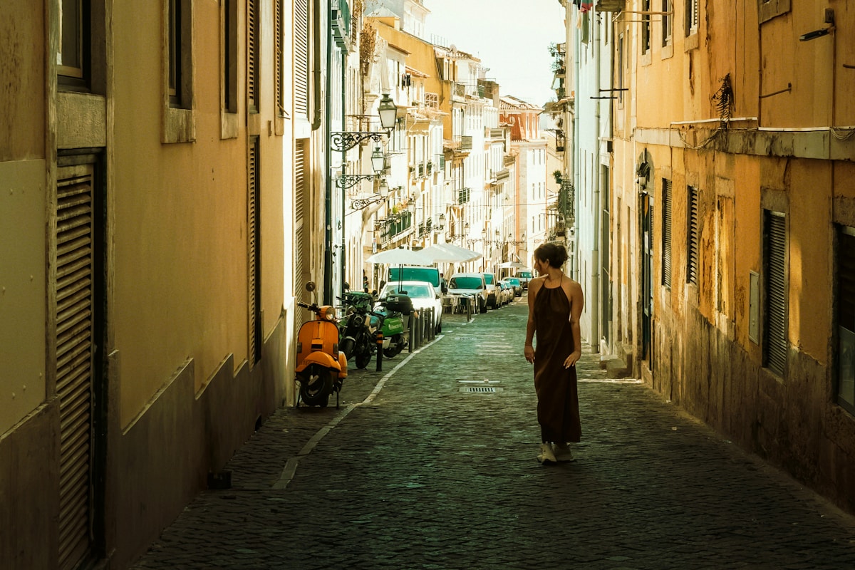 Lisbon's iconic yellow tram ascending a cobblestone street in the Bica neighbourhood