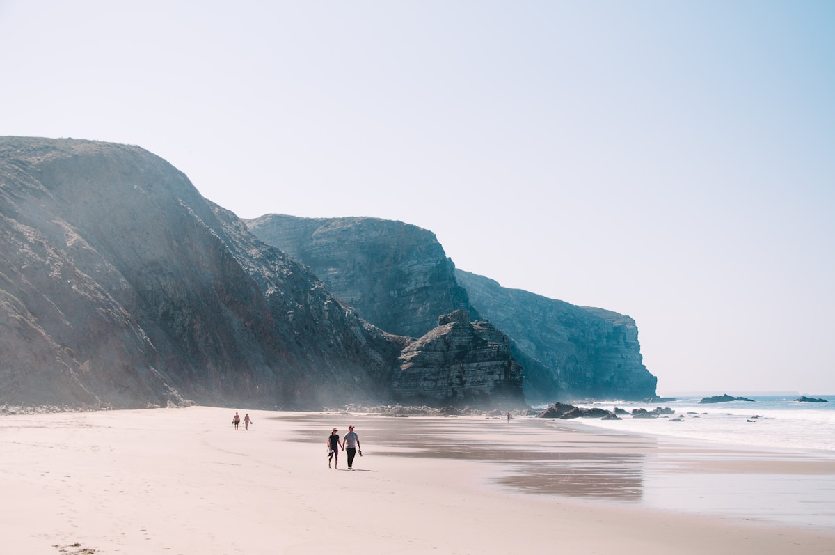 Wide sandy beach at Arrifana with dramatic cliffs rising above the bay, SW Alentejo coast, Portugal