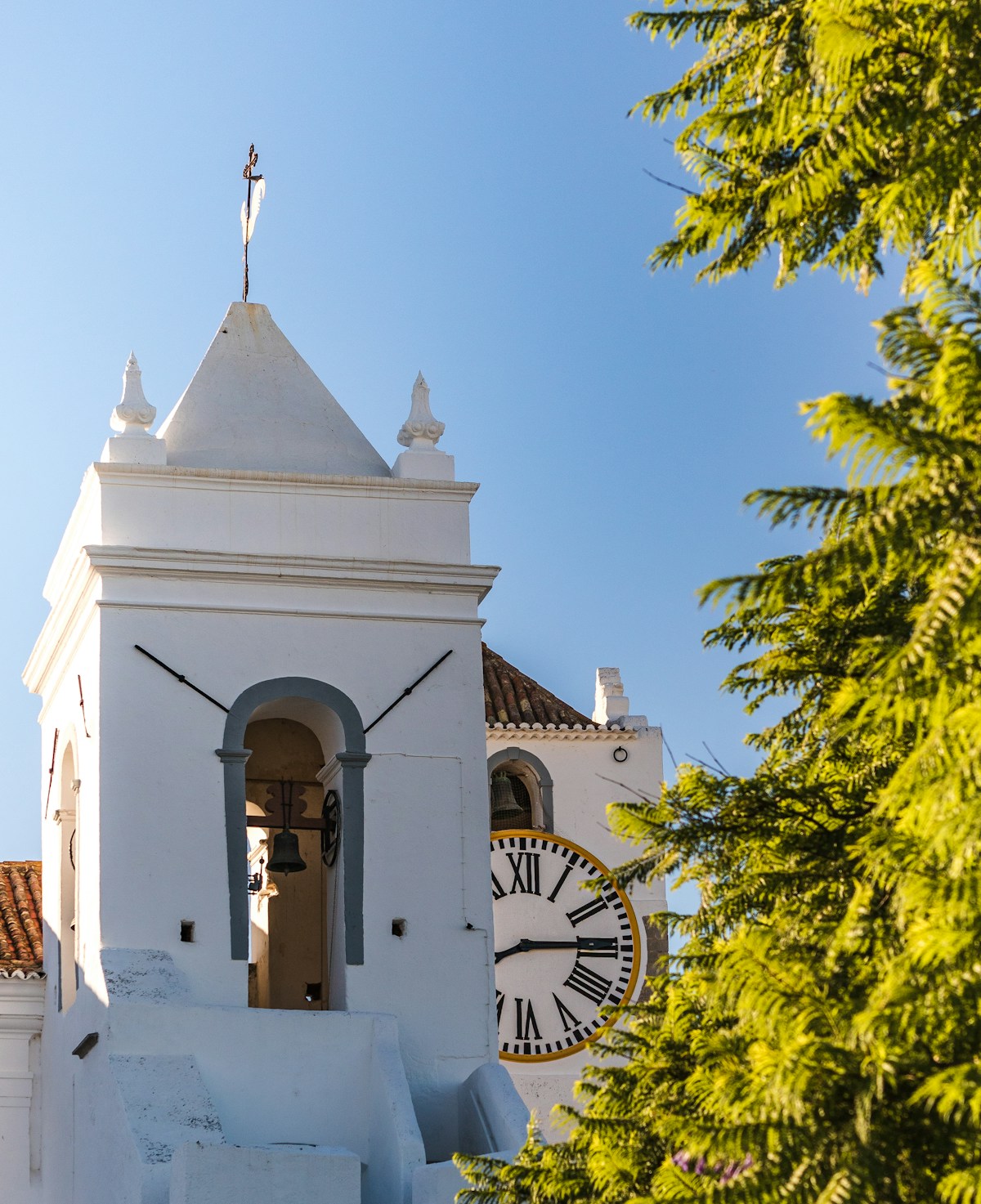 Tavira's Roman bridge crossing the Gilão River with the town's terracotta rooftops and castle behind