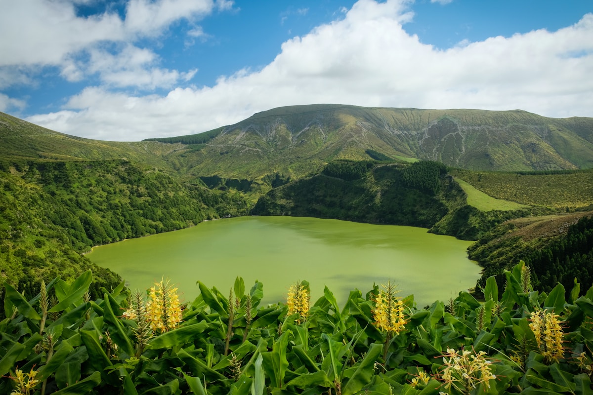 Green caldera lake surrounded by tropical vegetation and volcanic mountains, Graciosa island, Azores, Portugal