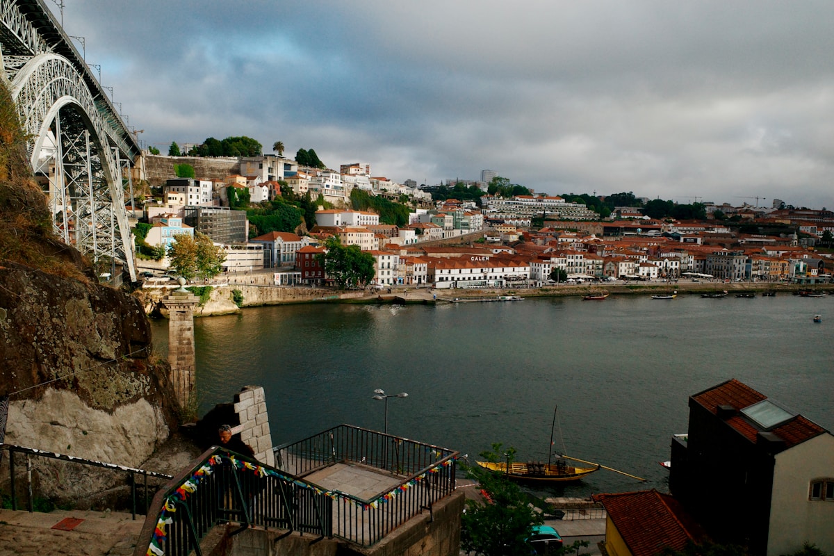 Dom Luís I bridge over the Douro river with Porto's terracotta rooftops and Ribeira waterfront below